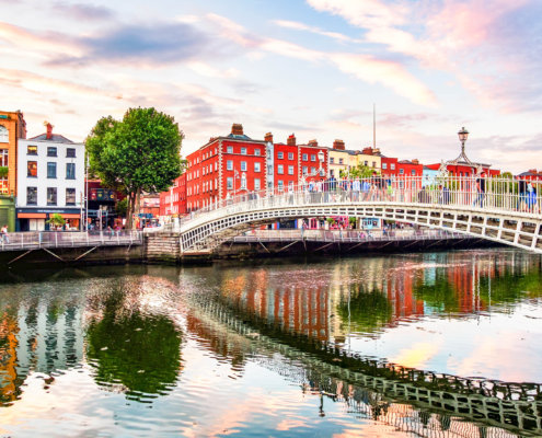 Night view of famous illuminated Ha Penny Bridge in Dublin, Ireland at sunset